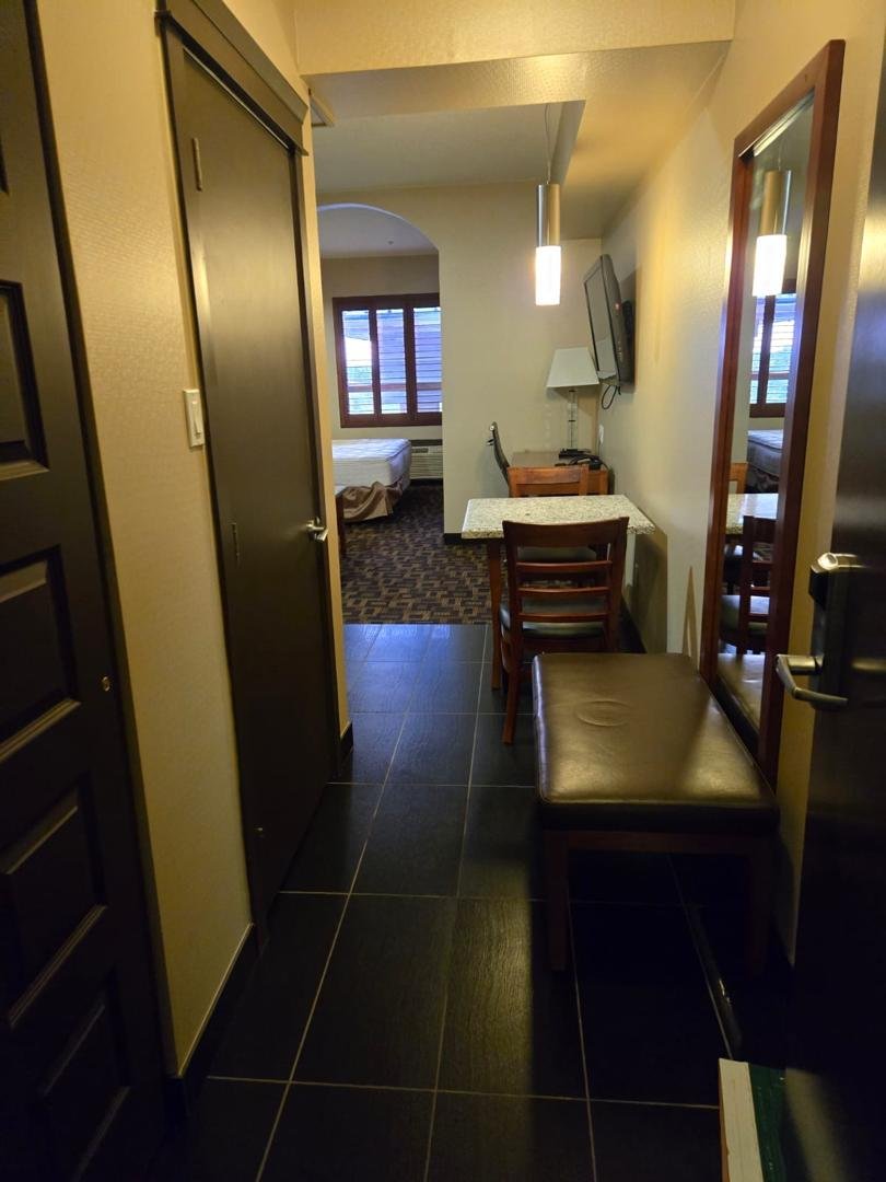 Hotel guest room entrance and dining area after reset