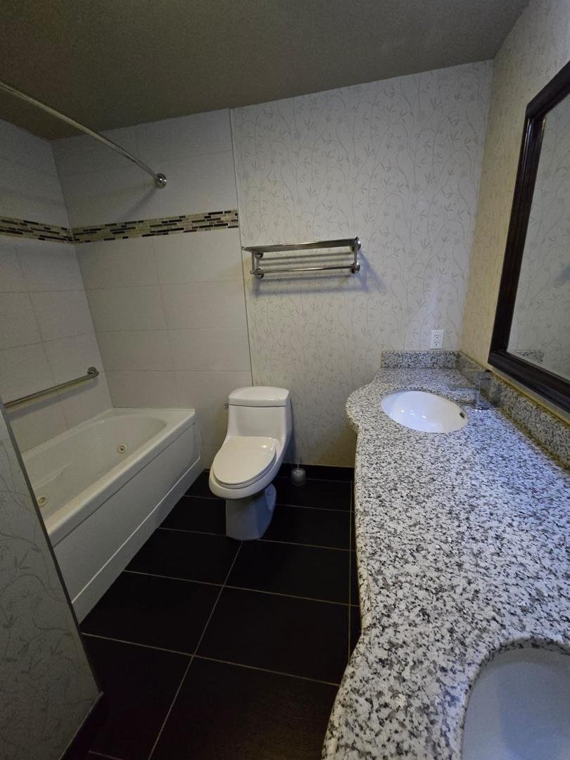 Hotel bathroom fixtures and vanity after cleaning